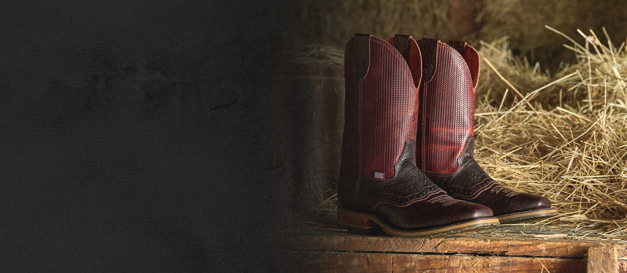 The Baler western boot in brown next to hay.